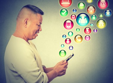 happy man using texting on smartphone social media application icons flying up