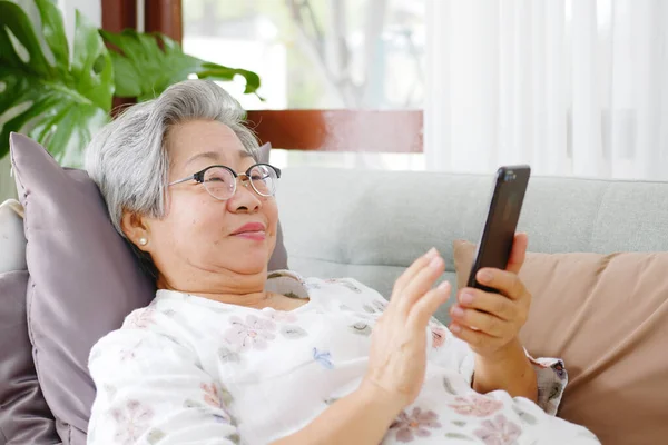 Senior Asian Woman Grey Hair Using Mobile Phone Relax Sofa Royalty Free Stock Photos