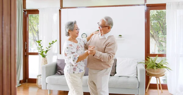 Asian Senior Couple Enjoy Dancing Relax Home Senior Retirement Lifestyle Stock Photo