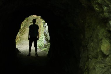Bir kaya tünelinde bir adam figürü