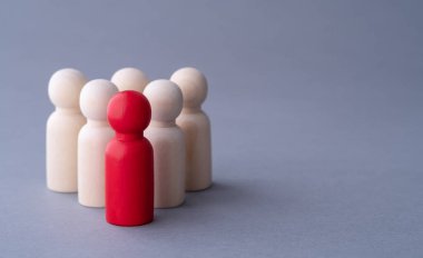 Tahtadan yapılmış kırmızı bir adam figürü, kalabalığın arasında duruyor. Farklı insanlar. Işıklar arasında eşsiz bir insan şekli. Liderlik, bireysellik ve kalabalığın dışında kalmak.