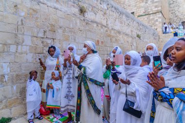 Jerusalem, Israel - May 01, 2021: Paschal Vigil (Easter Holy Saturday) dance of the Ethiopian Orthodox Tewahedo Church community, in the courtyard of Deir es-Sultan, Holy Sepulchre church, Jerusalem clipart