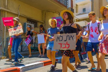 Haifa, Israel - July 09, 2021: Slut walk protest, against the rape culture: people with various signs marching in the street. Haifa, Israel