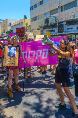 Haifa, Israel - July 09, 2021: Slut walk protest, against the rape culture: people with various signs marching in the street. Haifa, Israel