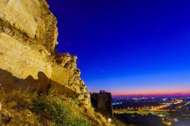 Evening view from the fortress towards Gush Dan (the urban area of Petah Tikva and Tel-Aviv), in Migdal Tsedek National Park, central Israel clipart