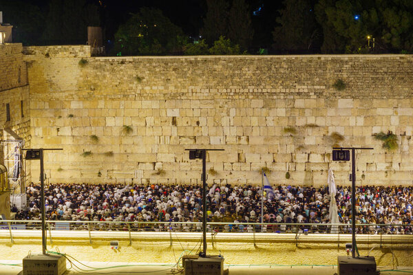 Jerusalem, Israel - August 31, 2021: Crowd of Jewish prayers attend a mass Selichot, Jewish penitential prays, at the Western Wall, Old City of Jerusalem, Israel