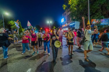 Hayfa, İsrail - 11 Ekim 2025: Çeşitli tabelaları ve bayrakları olan insanlar, savaşı sona erdirmek ve rehineleri serbest bırakmak için ateşkesi destekleyen bir protesto mitingine katıldılar. Hayfa, İsrail