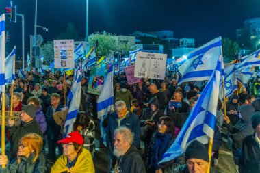 Haifa, Israel - January 03, 2026: Crowd of people with various signs and flags take part in a protest rally against the government. Haifa, Israel