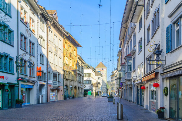 SCHAFFHAUSEN, SWITZERLAND - DECEMBER 26, 2015: Scene of Vorstadt street, with Oriel windows, painted facades, local businesses, locals and visitors, in Schaffhausen, Switzerland