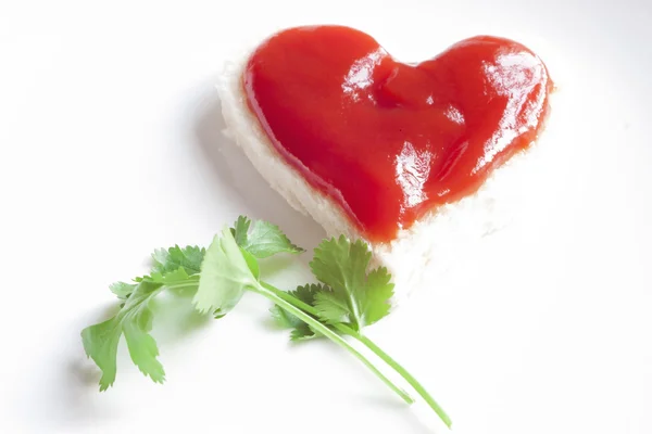 Bread and ketchup in shape of heart — Stock Photo, Image