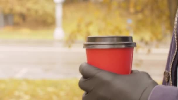 Mano masculina en guante protector sosteniendo una taza desechable — Vídeo de stock