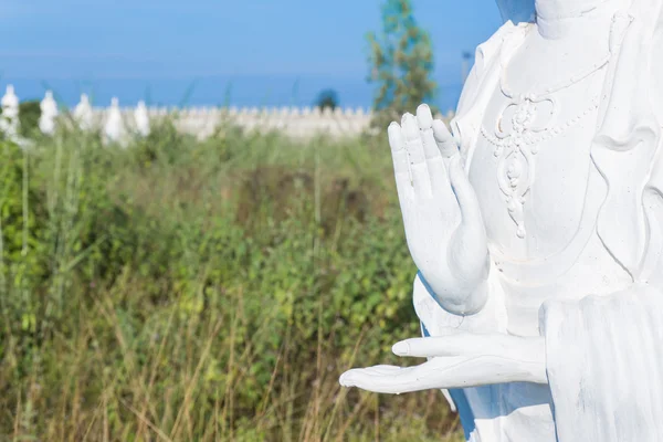 Close-up van de hand van witte buddha status op blauwe hemelachtergrond — Stockfoto