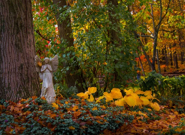 Statue of angel in garden with subtle vintage styling