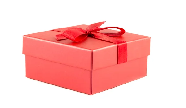 Red box with a ribbon on a white background — Stock Photo, Image