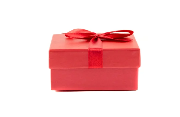 Red box with a ribbon on a white background — Stock Photo, Image