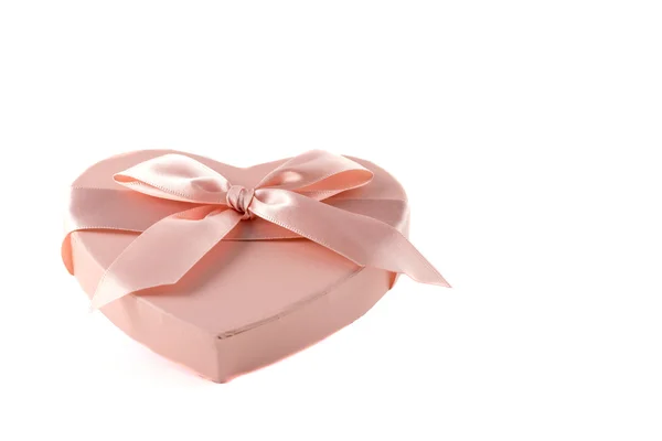 Pink heart-shaped box with purple ribbon knot — Stock Photo, Image