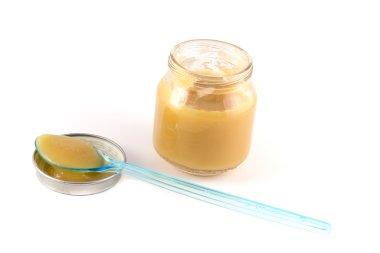 Plastik bir kaşıkla tencerede bebek meyve püresi