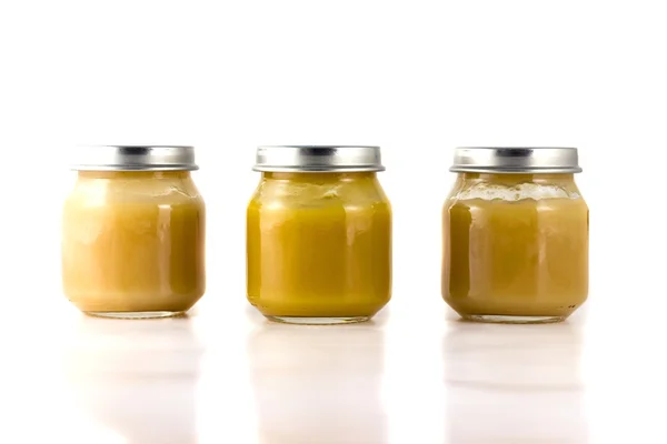 Three jars of fruit puree in a row — Stock Photo, Image
