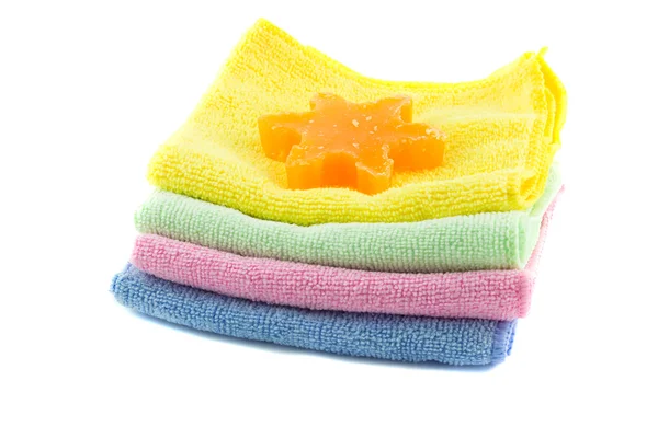 A stack of colorful towels and soap in the shape of a star-shape — Stock Photo, Image