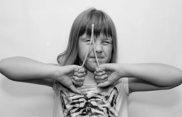 Girl and sticks — Stock Photo, Image