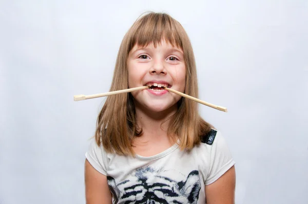 Girl and sticks — Stock Photo, Image