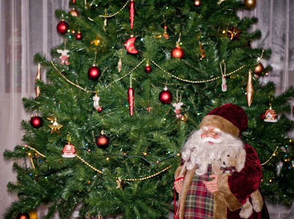 Santa doll under Christmas tree — Stock Photo, Image