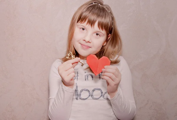 Beautiful teen girl with heart and key — Stock Photo, Image