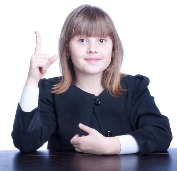 Nice Schoolgirl in black-and-white uniform sitting at a table — Stock Photo, Image