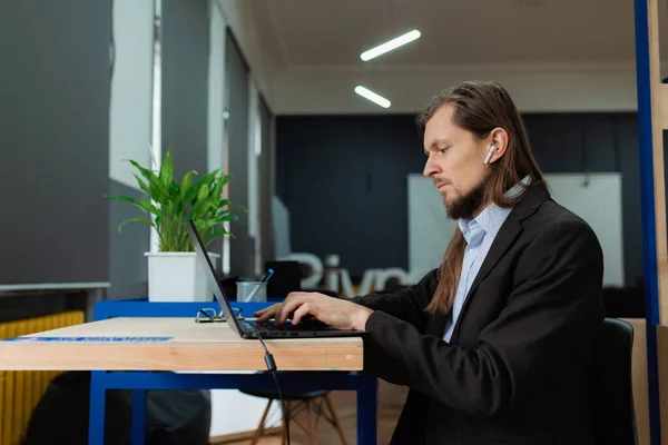 An official working on a laptop at daytime