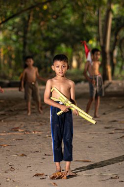 Bayrağı taşıyan Endonezya 'nın bağımsızlık baskısında oynayan ve heyecanlanan köy çocuklarının konsept fotoğrafı. : Bantul, Endonezya - 15 Ağustos 2021