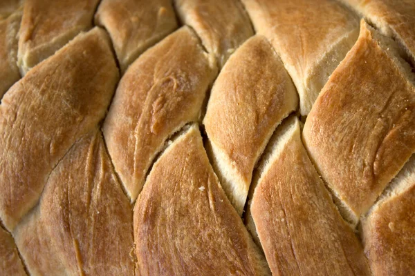 Homemade bread texture close up. Sweet bun top view photo.