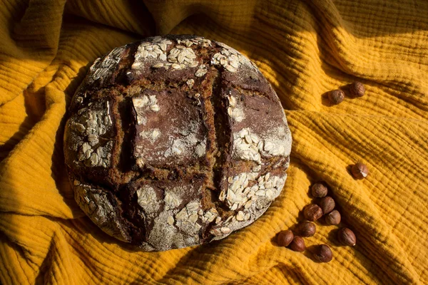 Rye sourdough bread with hazelnuts. Top view photo of freshly baked artisan bread. Healthy eating concept.