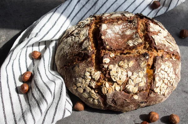 Rye sourdough bread with hazelnuts. Top view photo of freshly baked artisan bread. Healthy eating concept.