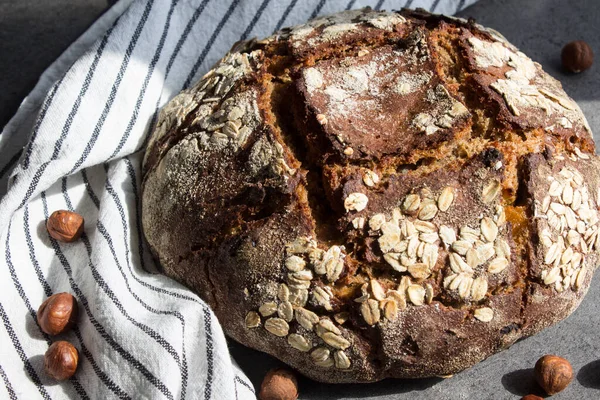 Rye sourdough bread with hazelnuts. Top view photo of freshly baked artisan bread. Healthy eating concept.