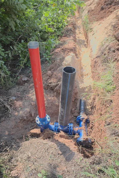 Plumbing During construction,Plastic pipes in the ground,Red pipe for fire hydrant, black pipe, exposed earth, water supply