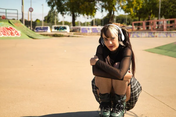 Punk Tarzı Beyaz Kulaklıklı Paten Takmış Bacaklarıyla Çömelmiş Şirin Bir — Stok fotoğraf