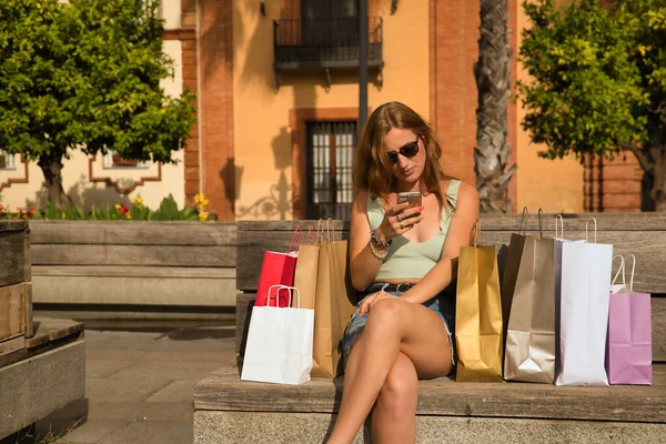 Молода Жінка Перевіряє Соціальні Мережі Мобільному Телефоні Сидячи Лавці Оточенні — стокове фото