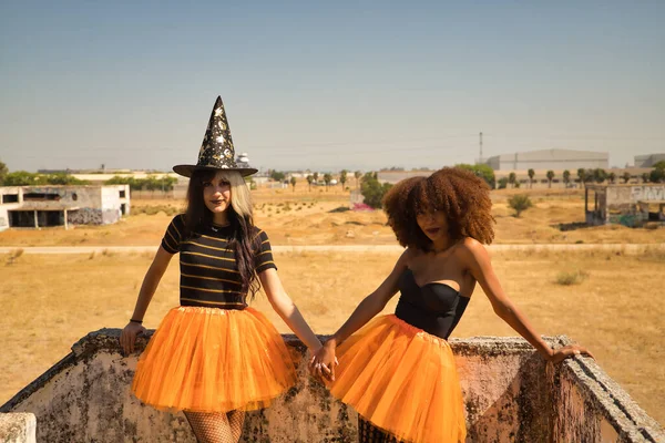 Young Hispanic Latina Women Holding Hands Leaning Stone Wall Dressed — Stok fotoğraf