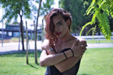 Genç İspanyol ve transseksüel kız gururla ve sevgiyle kendine sarılıyor. Transseksüellik, kapsama ve çeşitlilik kavramı.