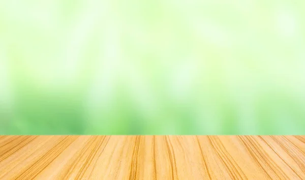 perspective wood table top on blur abstract green background