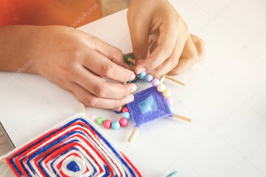 The hands of children are inventing toys, decorating the house.