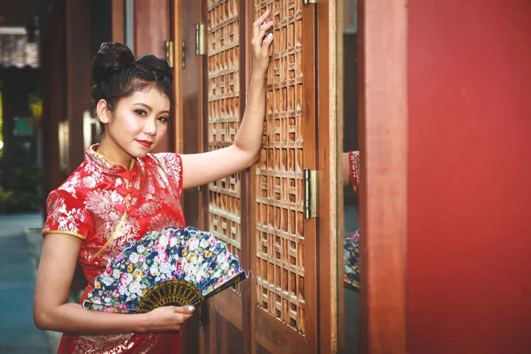 Asian women wearing Chinese clothes stand to blow