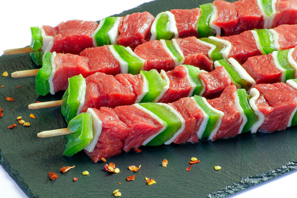 raw beef skewers isolated on a white background