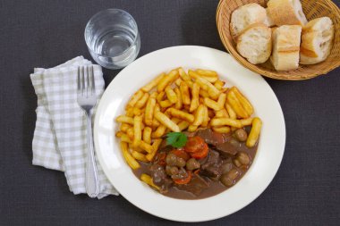 fried potatoes with stewed beef, mushrooms and carrot 
