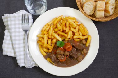 fried potatoes with stewed beef, mushrooms and carrot 