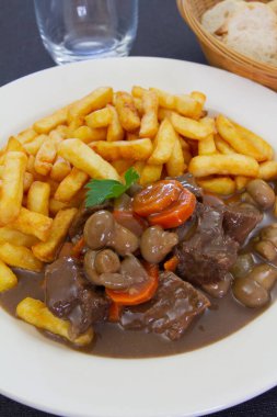 fried potatoes with stewed beef, mushrooms and carrot 