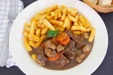fried potatoes with stewed beef, mushrooms and carrot 
