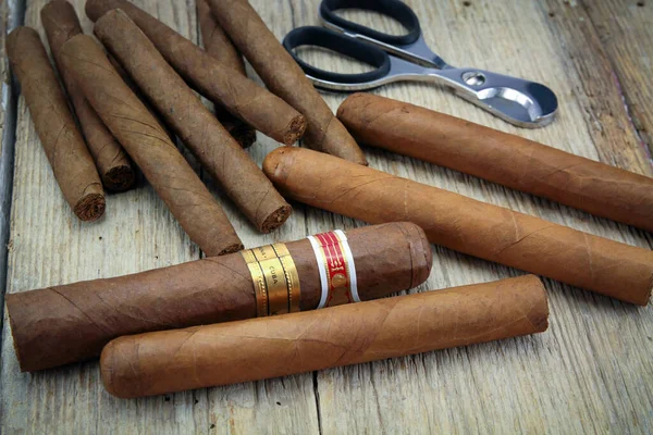 Several cigars of Cuba on a wooden table.