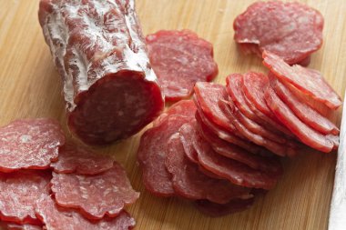 Kesme tahtasında dilimlenmiş sosis.