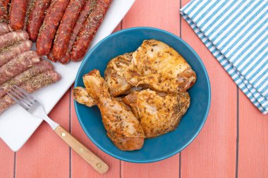 several raw marinated chicken pieces